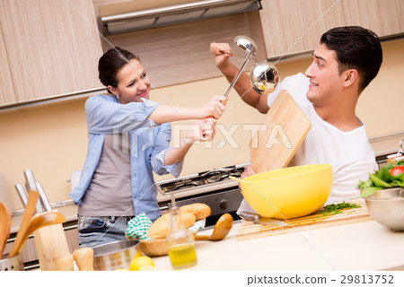 Young family doing funny fight at kitchen Young family doing funny fight at kitchen 29813752