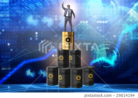 Businessman on top of oil barrels 29814194