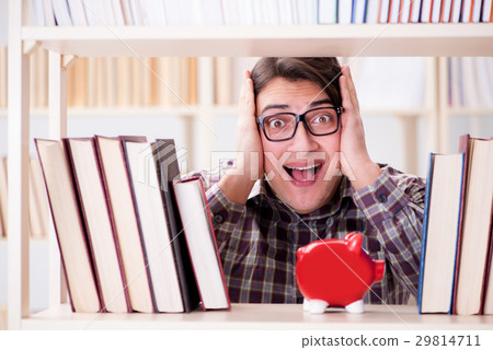 Young student in expensive textbooks concept Young student in expensive textbooks concept 29814711
