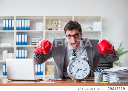 Angry businessman with boxing gloves in time Angry businessman with boxing gloves in time 29815339