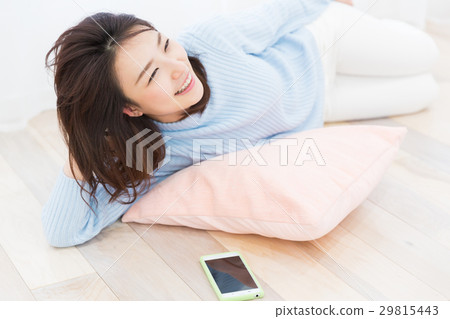 Woman looking at smartphone in the room Woman looking at smartphone in the room 29815443