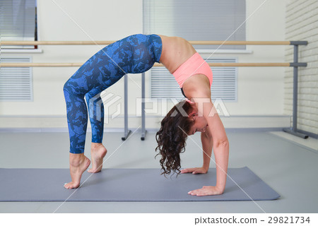 Beautiful young woman working out in fitness class 29821734