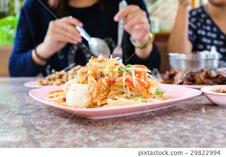 People enjoying eating thai food " Som Tam " People enjoying eating thai food " Som Tam " 29822994