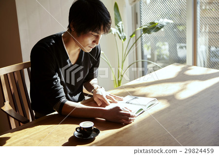 A man who reads in a sunny room. Scenes relaxing on holiday, sunny dining. A man who reads in a sunny room. Scenes relaxing on holiday, sunny dining. 29824459