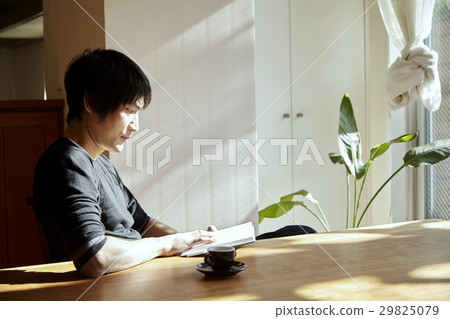 A man who reads in a sunny room. Scenes relaxing on holiday, sunny dining. A man who reads in a sunny room. Scenes relaxing on holiday, sunny dining. 29825079