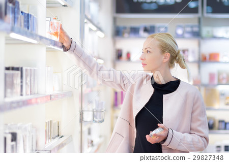 Beautiful woman shopping in beauty store. Beautiful woman shopping in beauty store. 29827348