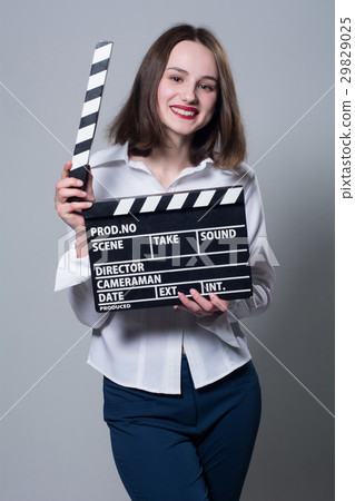 Smiling brunette in white blouse with movie 29829025