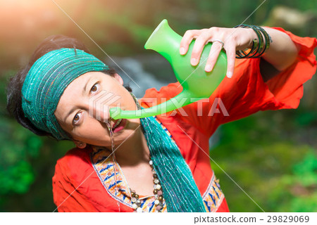Jala neti nasal irrigation with a woman in nature Jala neti nasal irrigation with a woman in nature 29829069