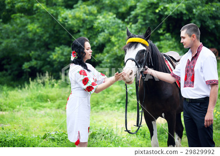 Couple in Ukrainian costumes with a horse Couple in Ukrainian costumes with a horse 29829992