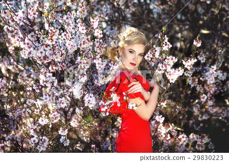 Beautiful young woman in nice red dress posing on 29830223