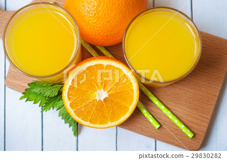 Glass of orange juice from above on wood table. 29830282
