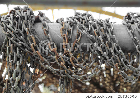 Pattern of thick rusty chain hang on iron rail. 29830509