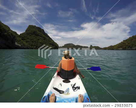 Young woman and man - couple kayaking in beautiful Young woman and man - couple kayaking in beautiful 29833075