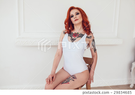 Beautiful sexy girl with red hair and tattoo Beautiful sexy girl with red hair and tattoo 29834685