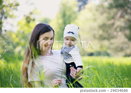 Mother and son shows the grass Mother and son shows the grass 29834686