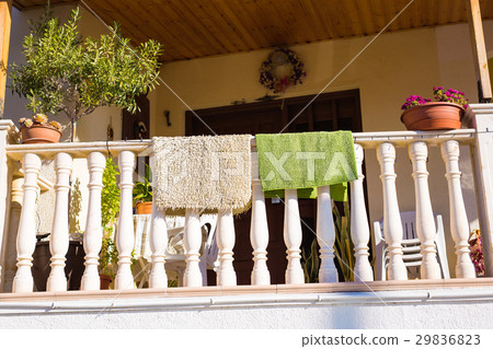 Drying rugs hanging on the balcony 29836823