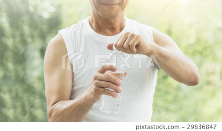 Close up Asian senior man holding bottle of water Close up Asian senior man holding bottle of water 29836847