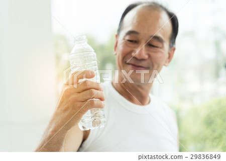 Close up Asian senior man holding bottle of water  29836849