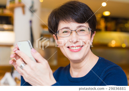Attractive smiling woman using mobile phone 29836881