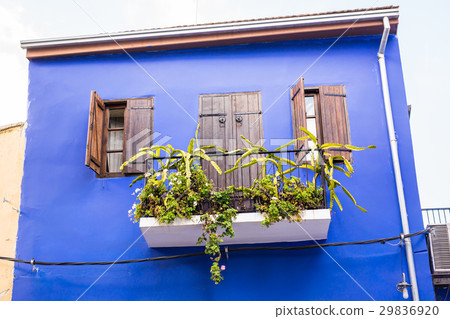 Balconies and the walls blue. 29836920