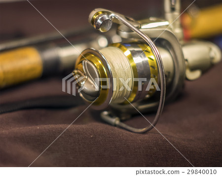 Beautiful gold fishing rod and reel closeup Beautiful gold fishing rod and reel closeup 29840010