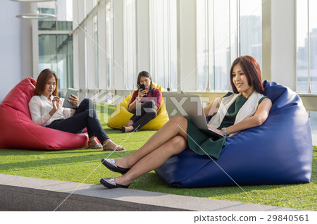 Three Asian Women using social network each technology equipment In the modern creative Office, business social network concept Three Asian Women using social network each technology equipment In the modern creative Office, business social network concept 29840561