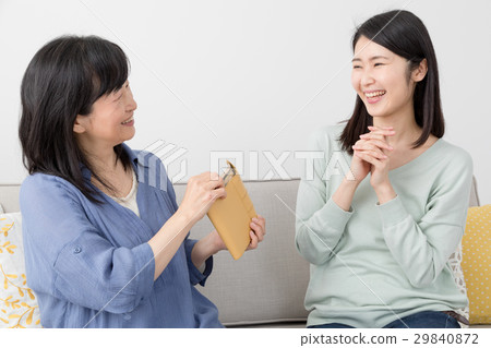A girl receiving pocket money from my mother A girl receiving pocket money from my mother 29840872