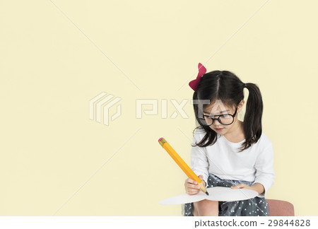 Little girl studio isolated writing on notebook 29844828