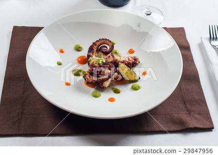 close up of cooked octopus on a white plate close up of cooked octopus on a white plate 29847956