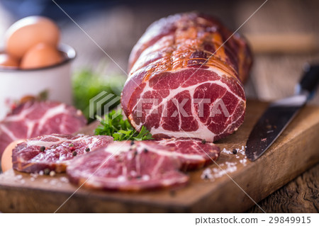 Traditional smoked pork meat on oak wooden table. Traditional smoked pork meat on oak wooden table. 29849915