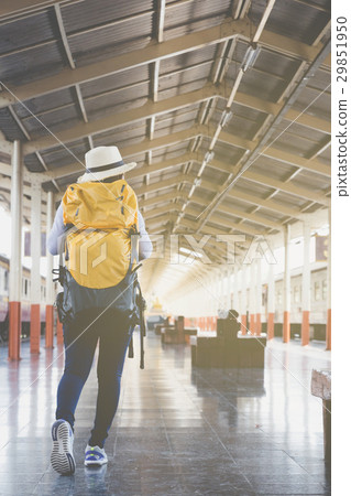 woman on train station platform with backpack  29851950