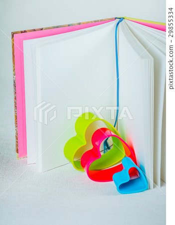 Blue red and green hearts inside an open book with 29855334