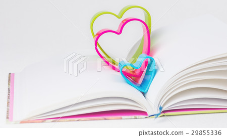 Red blue and green hearts over diary book on white Red blue and green hearts over diary book on white 29855336