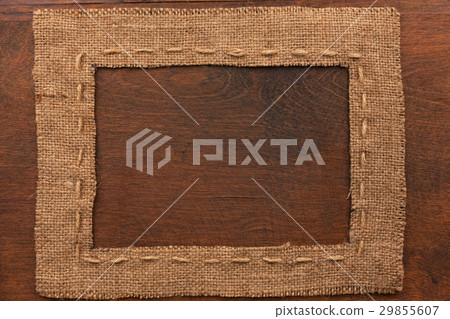 Frame of burlap, lies on a background of wood Frame of burlap, lies on a background of wood 29855607