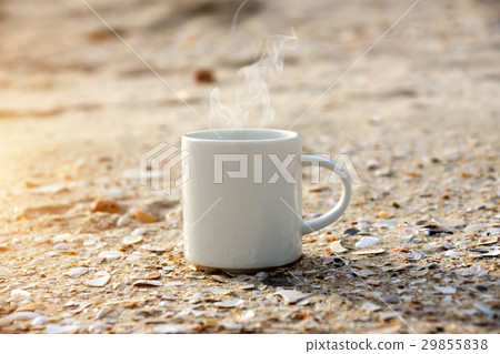 White coffee mug on the beach. 29855838