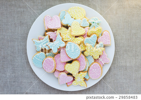 Colorful Easter cookies on  plate on tablecloth 29858483