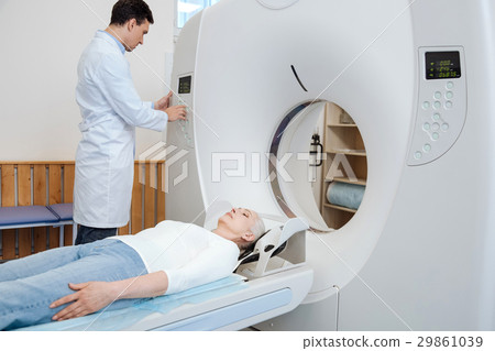 Serious male doctor using MRI scanner 29861039