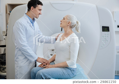 Handsome joyful doctor telling his patient a 29861150
