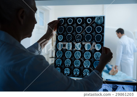 Experienced intelligent oncologist looking at the Experienced intelligent oncologist looking at the 29861203