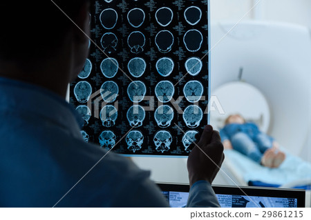 MRI scan images being examined by a doctor 29861215