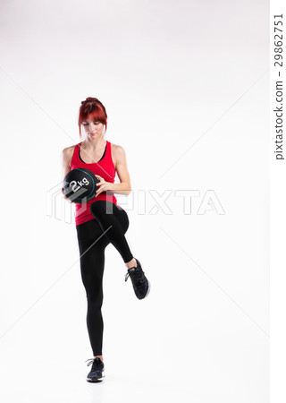 Fitness woman in red tank top holding medicine Fitness woman in red tank top holding medicine 29862751