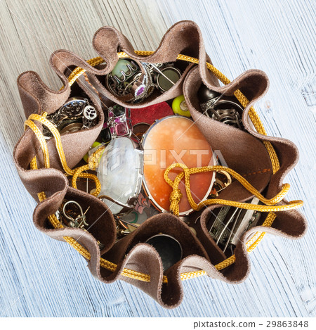 top view of open leather purse with jewelry 29863848