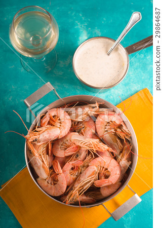 Shrimps on a yellow napkin, glass with white wine Shrimps on a yellow napkin, glass with white wine 29864687