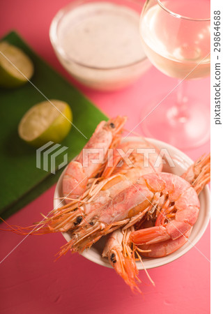 Shrimps in a ceramic bowl, a glass of white wine Shrimps in a ceramic bowl, a glass of white wine 29864688