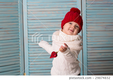 playful baby in bright red hat blue background playful baby in bright red hat blue background 29874832