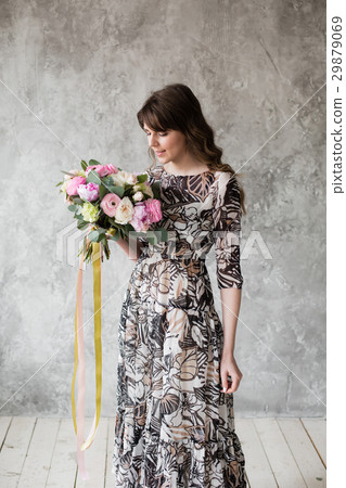 Happy beautiful young woman holding bouquet of 29879069