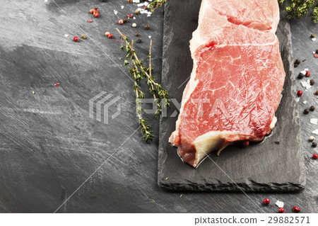Piece of raw meat of beef on a slate board 29882571