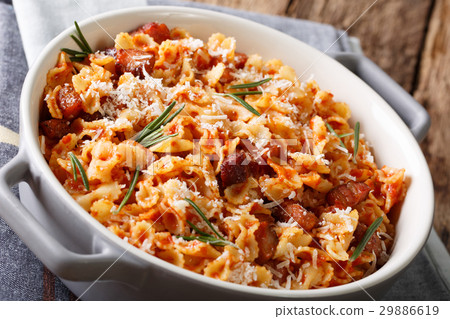 Baked pasta with tomato, bacon and cheese 29886619