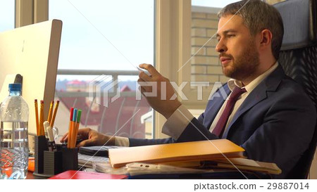 Handsome bearded man paying online with his credit 29887014