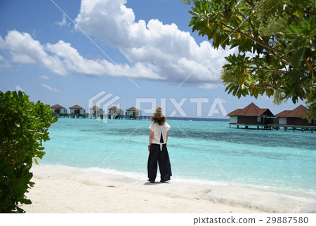 Maldives beach woman watching the sea 29887580